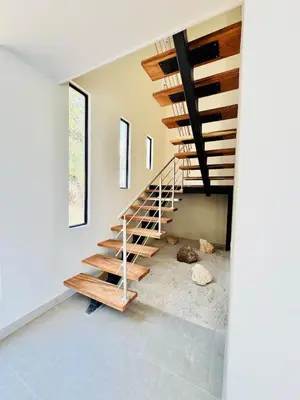 a staircase in a house with a dog laying on the floor at Coco Rica Luxury Oceanview Villa Pool Concierge 4 Bedroom 6BED 5BA Playa Carrillo in Carrillo
