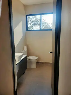 a bathroom with a toilet and a sink and a window at Coco Rica Luxury Oceanview Villa Pool Concierge 4 Bedroom 6BED 5BA Playa Carrillo in Carrillo