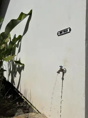 a sign on the side of a building with a chain at Jungle Bungalow at Oropel Lodge in Puerto Viejo