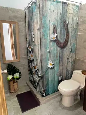 a bathroom with a toilet and a wooden wall at Apartamento con piscina privada in Uvita
