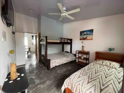 a bedroom with two bunk beds and a ceiling fan at Apartamento con piscina privada in Uvita