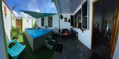 a patio with a blue table and chairs at Apartamento con piscina privada in Uvita