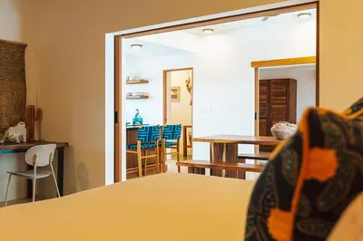a room with a bed and a dining room at Casa Cadejo- Incredible Surf House In Playa Grande in Playa Grande