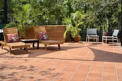 a patio with two benches and two chairs at Casa Cadejo- Incredible Surf House In Playa Grande in Playa Grande