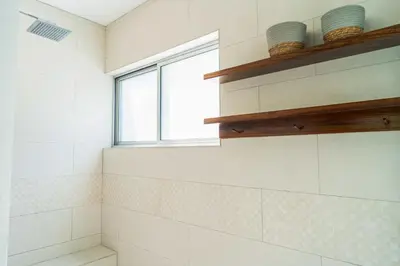 a bathroom with a shower with a window at Casa Lapas in Uvita