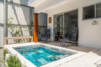 a swimming pool in front of a house at Casa Lapas in Uvita