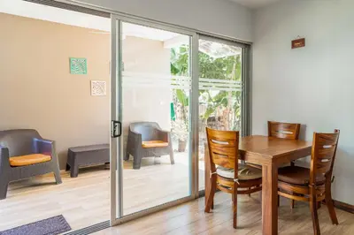 a dining room with a table and chairs at Casa Lapas in Uvita