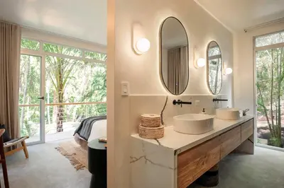 a bathroom with two sinks and a large mirror at Om at Namaste Oasis Condo in Nosara