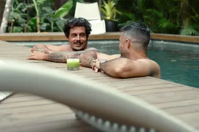 two men laying in a swimming pool at Om at Namaste Oasis Condo in Nosara