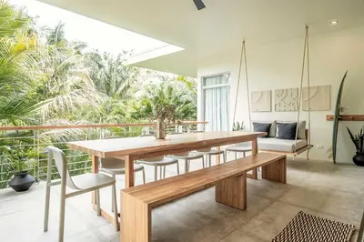 a dining room with a wooden table and chairs at Om at Namaste Oasis Condo in Nosara