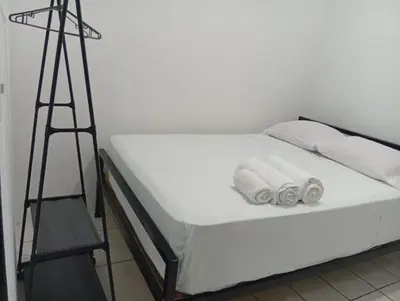 a bed with a ladder and two pairs of shoes on it at Apartamentos GoZu # 2 in Puerto Viejo