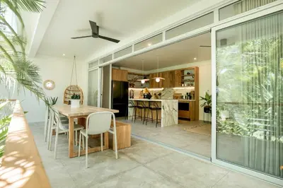 a dining room and kitchen with a table and chairs at Prana at Namaste Oasis Condo in Nosara