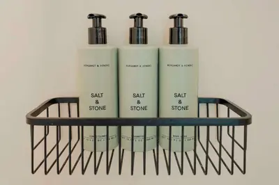 a shelf with four bottles of salt and stone at Prana at Namaste Oasis Condo in Nosara
