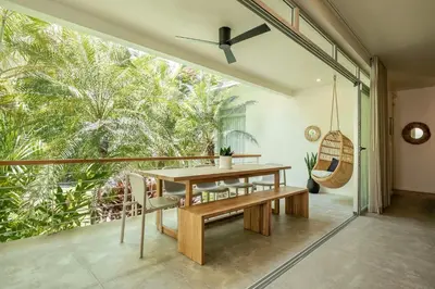 a dining room with a table and a large window at Prana at Namaste Oasis Condo in Nosara