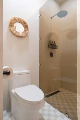 a bathroom with a toilet and a shower at Prema at Namaste Oasis Condo in Nosara