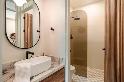a bathroom with a sink and a mirror at Prema at Namaste Oasis Condo in Nosara
