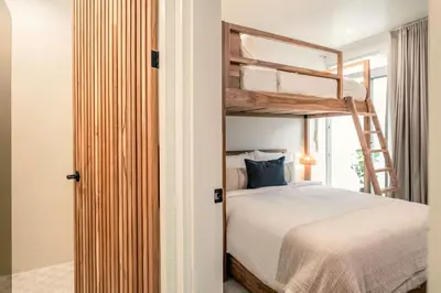 a bedroom with a bunk bed and a ladder at Sukha at Namaste Oasis Condo in Nosara