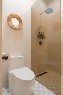 a bathroom with a toilet and a shower at Sukha at Namaste Oasis Condo in Nosara
