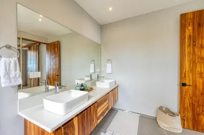 a bathroom with two sinks and a large mirror at Villa Kañik - Luxury Retreat with Concierge Services in Dominical