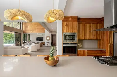 a kitchen and living room with a pineapple on the counter at Villa Kañik - Luxury Retreat with Concierge Services in Dominical