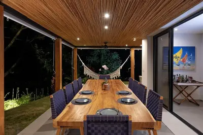 a wooden table and chairs in a room at Villa Kañik - Luxury Retreat with Concierge Services in Dominical