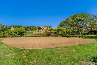a soccer field with a net in the grass at Ciudad del Mar 70 in Jacó