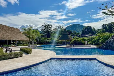 a swimming pool with a waterfall in a resort at Ciudad del Mar 70 in Jacó