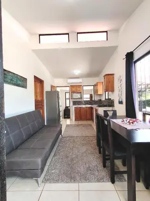 a living room with a couch and a table at Casa Chika, Playa Grande Guanacaste, Casa Completa in Cuajiniquil