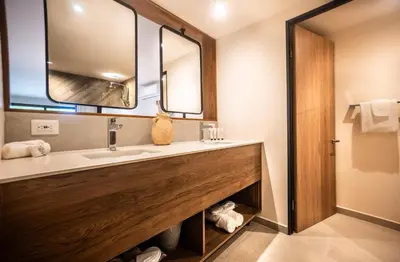 a bathroom with a sink and a mirror at Lia Hotel Jaco - Adults Only in Jacó