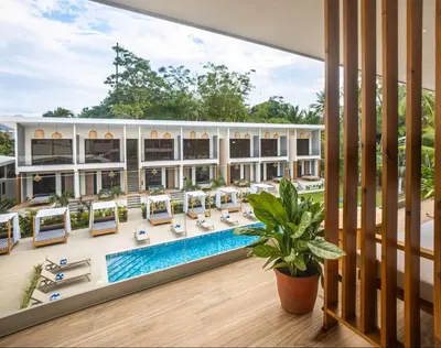 an image of a resort with a pool and lounge chairs at Lia Hotel Jaco - Adults Only in Jacó