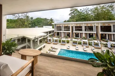 a view of the pool from the balcony of a hotel at Lia Hotel Jaco - Adults Only in Jacó