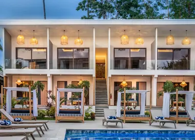 an exterior view of a building with a swimming pool at Lia Hotel Jaco - Adults Only in Jacó