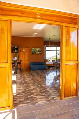 an open living room with a table and chairs at San Gabriel Kalyäkä No 02 in San Gabriel