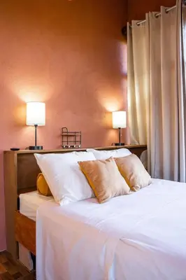a bedroom with a bed with two lamps on it at San Gabriel Kalyäkä No 02 in San Gabriel