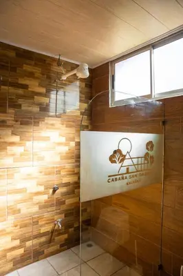 a bathroom with a shower with a sign on the wall at San Gabriel Kalyäkä No 02 in San Gabriel