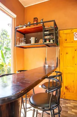 a table with four chairs in a room with a window at San Gabriel Kalyäkä No 02 in San Gabriel