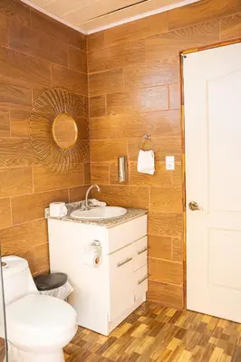 a bathroom with a toilet and a sink at San Gabriel Kalyäkä No 02 in San Gabriel