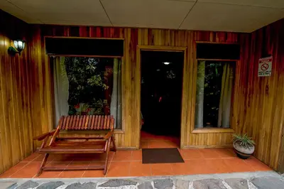 a bench sitting on the porch of a house at Hospedaje Mariposa in Monteverde Costa Rica
