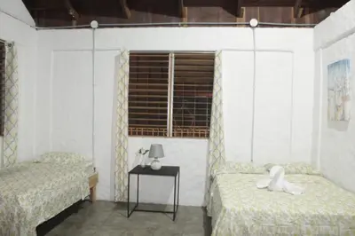 a room with two beds and a window at Ocean View Tambor in Tambor