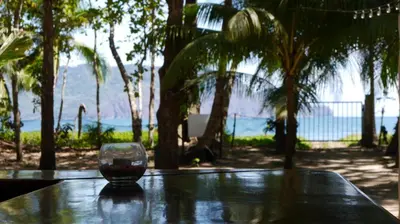 a glass of wine sitting on top of a table at Ocean View Tambor in Tambor