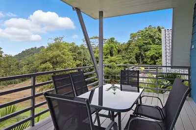 a patio with a table and chairs on a balcony at Junglo Resort and Spa in Fortuna