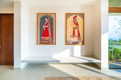two paintings of women on a wall in a room at Casa Bella Vina - by Pura Villas in Dominical