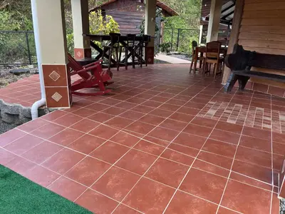 a patio with a tiled floor on a house at Aire Agua y Naturaleza in Guácimo