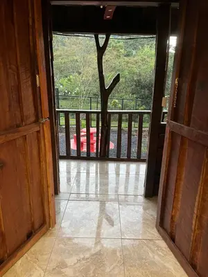 an open door to a balcony with a tree outside at Aire Agua y Naturaleza in Guácimo