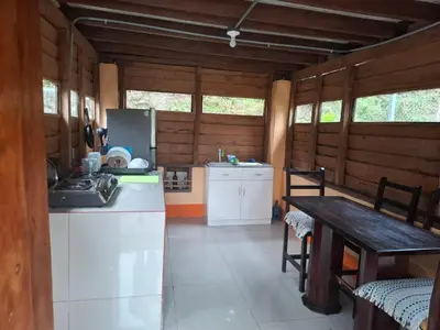 a kitchen with a counter and a table in a room at Aire Agua y Naturaleza in Guácimo