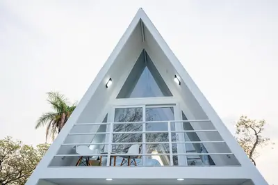 a triangular house with a window at Casa Clara Monteverde in Puntarenas