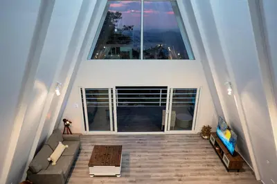 an overhead view of a living room with a large window at Casa Clara Monteverde in Puntarenas