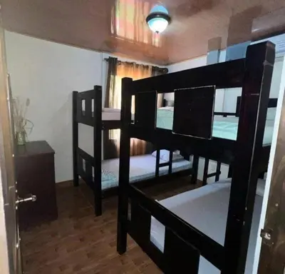a room with three bunk beds in a room at Villas BRENES in Uvita