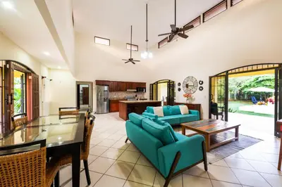 a dining room and living room with a dining table at Villa Tropical by Vacation Pura Vida in Esterillos Este