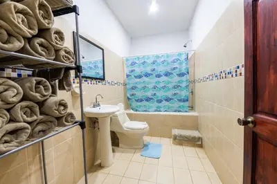 a bathroom with a toilet and a sink at Villa Tropical by Vacation Pura Vida in Esterillos Este